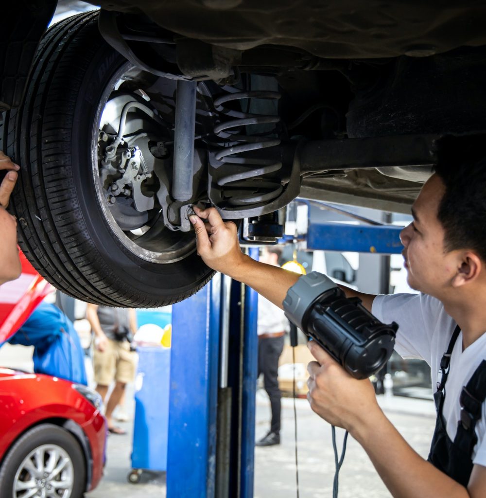 two-mechanic-was-checking-the-car-suspension-.jpg